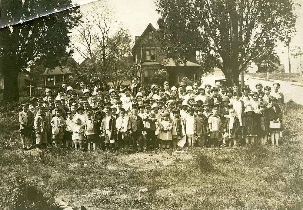 Sepia portrait of Japanese American children standing/sitting in a field